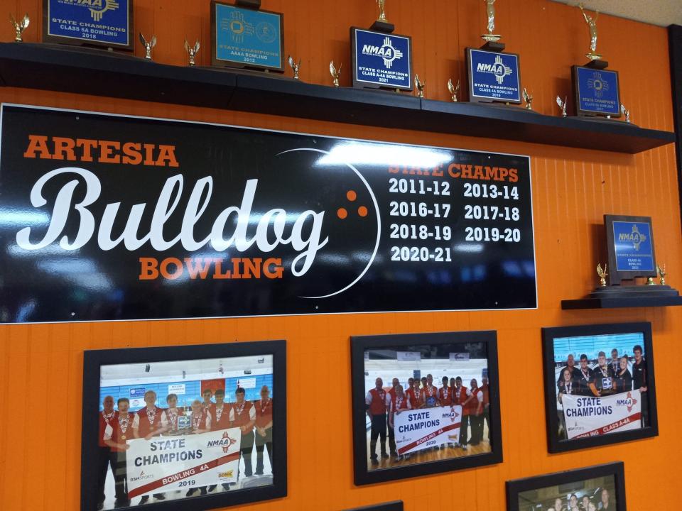 Trophies and a plaque adorn a wall at Artesia Lanes Bowling Center as the Artesia High School bowling team prepares to win its ninth state title.