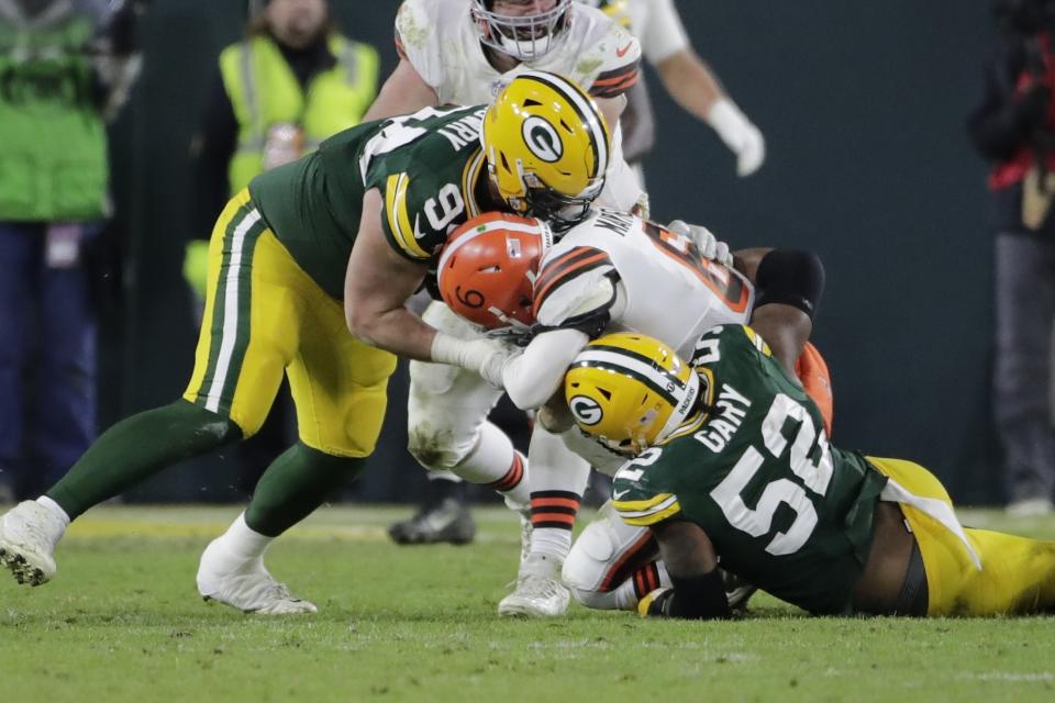 Green Bay Packers' Rashan Gary sacks Cleveland Browns' Baker Mayfield during the second half of an NFL football game Saturday, Dec. 25, 2021, in Green Bay, Wis. (AP Photo/Aaron Gash)