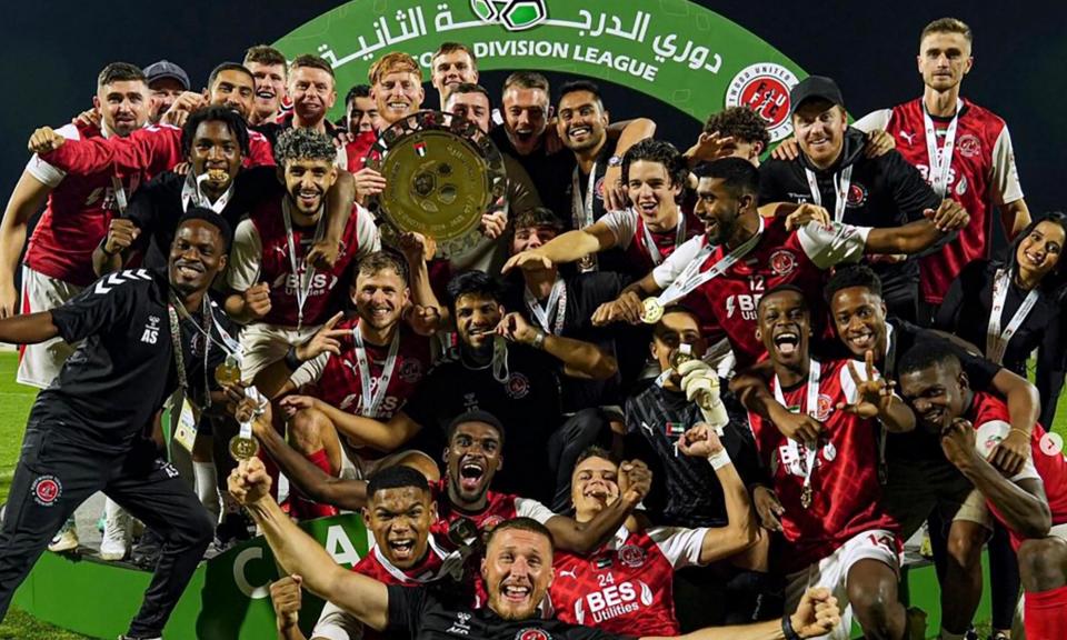 <span>Fleetwood United players and staff celebrate on 6 April 2024 after winning the United Arab Emirates second division.</span><span>Photograph: fleetwoodunitedfc/instagram</span>