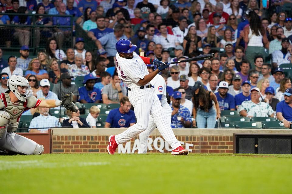 Aug 2, 2023; Chicago, Illinois, USA; Chicago Cubs third baseman Jeimer Candelario (9) hits a double against the Cincinnati Reds during the third inning at Wrigley Field.