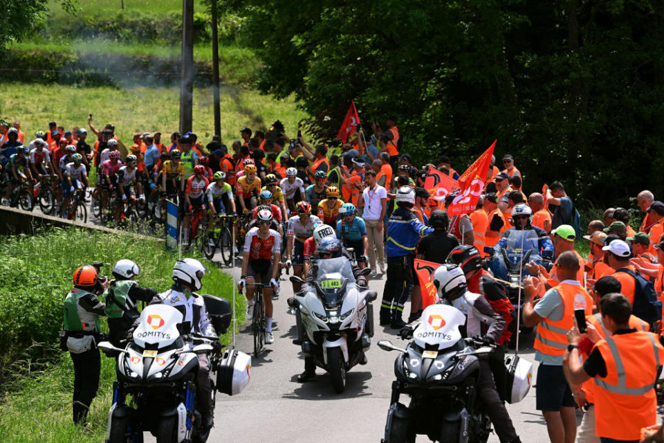 LE COTEAU FRANCE  JUNE 06 The peloton resumes the route after being cut off by demonstrators in the village of Marols during the 75th Criterium du Dauphine 2023 Stage 3 a 1941km stage from MonistrolsurLoire to Le Coteau  UCIWT  on June 06 2023 in Le Coteau France Photo by Dario BelingheriGetty Images