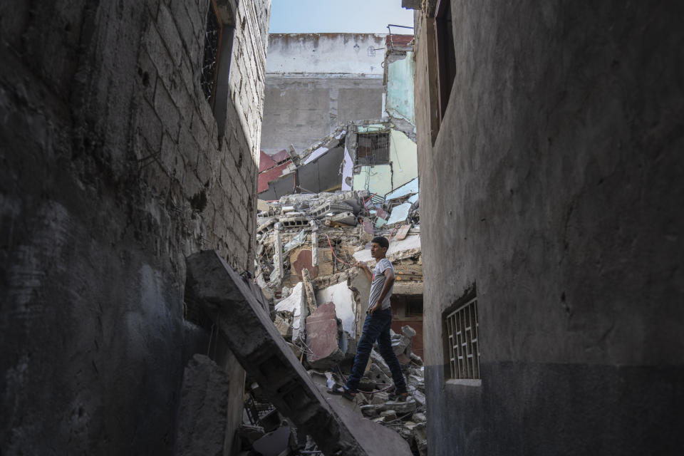 A man walks through the wreckage of his that was caused by the September earthquake, in Moulay Ibrahim, outside Marrakech, Morocco, Friday, Oct. 6, 2023. Morocco has pledged to rebuild from a September earthquake in line with its architectural heritage. Villagers and architects agree that earthquake-safe construction is a top priority. That’s created a push for modern building materials. But the government says it wants to rebuild in line with Morocco’s cultural and architectural heritage. (AP Photo/Mosa'ab Elshamy)