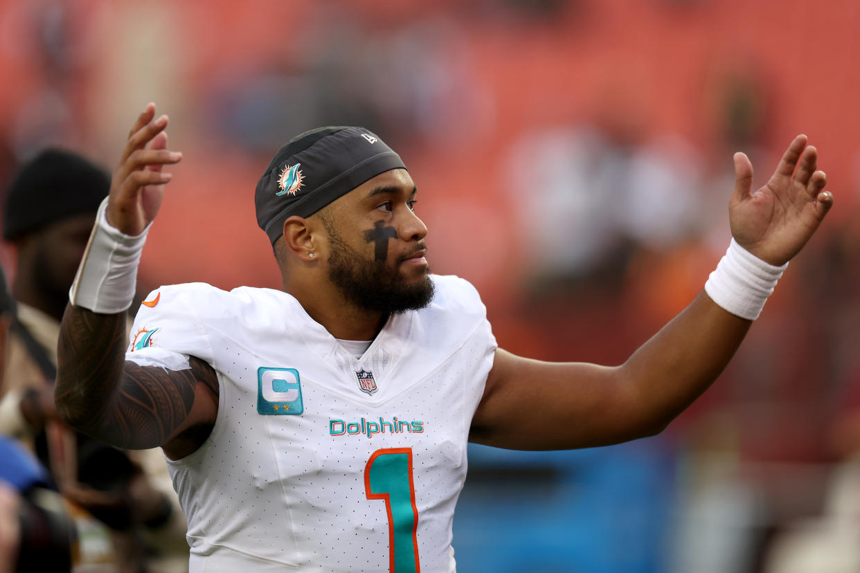 LANDOVER, MARYLAND - DECEMBER 03: Quarterback Tua Tagovailoa #1 of the Miami Dolphins celebrates following the Dolphins win over the Washington Commanders at FedExField on December 03, 2023 in Landover, Maryland. (Photo by Rob Carr/Getty Images)