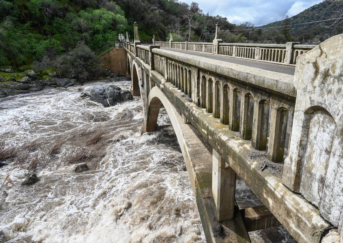 Heavy storm runoff fills the Kaweah River at the Pumpkin Hollow Bridge and the Gateway Restaurant and Lodge on Highway 198 in Three Rivers on Saturday, March 11, 2023.