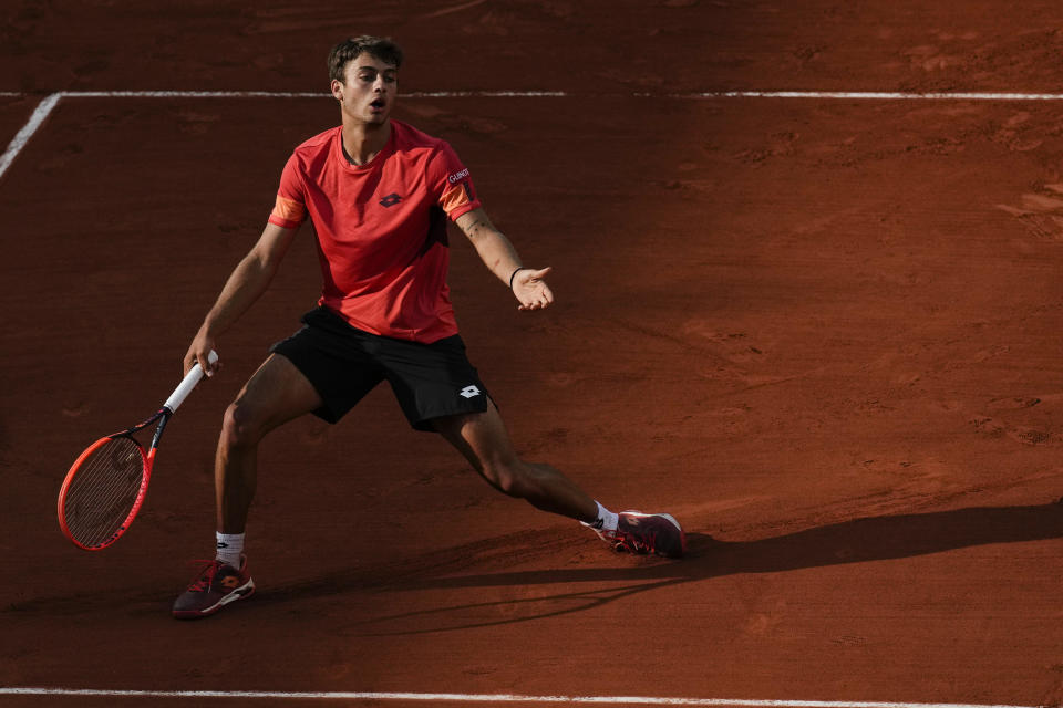 Italy's Flavio Cobolli reacts after missing a shot against Spain's Carlos Alcaraz during their first round match of the French Open tennis tournament at the Roland Garros stadium in Paris, Monday, May 29, 2023. (AP Photo/Christophe Ena)