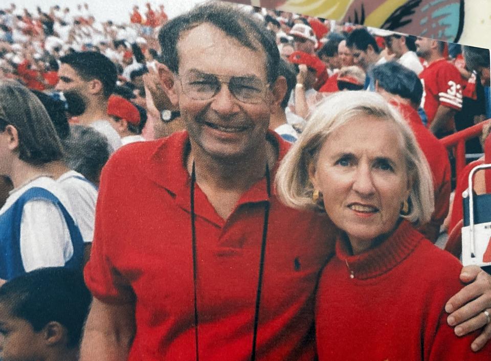 Dr. Rolf Lulloff poses with his wife, Ann, at a Badgers game. Ann lived with Parkinson's before her death in 2021.