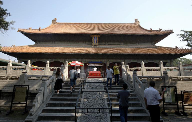 File photo of tourists visiting the Temple of Confucius in Qufu, eastern China's Shandong province, taken on September 3, 2013