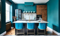 <p> This kitchen has base cabinetry in a dark blue, but the use of a toning color on the walls – here a bright turquoise – creates a much bolder finish.  </p> <p> This is a clever technique, choosing painted kitchen cabinets that are easy to redecorate around, timelessly fashionable and easy to sell to future buyers, but adding pep with a wall color that can be quickly and easily changed when the scheme needs a switch up. </p>