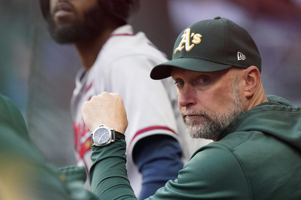 Oakland Athletics manager Mark Kotsay watches from the dugout during the team's baseball game against the Atlanta Braves Wednesday, June 8, 2022, in Atlanta. (AP Photo/John Bazemore)