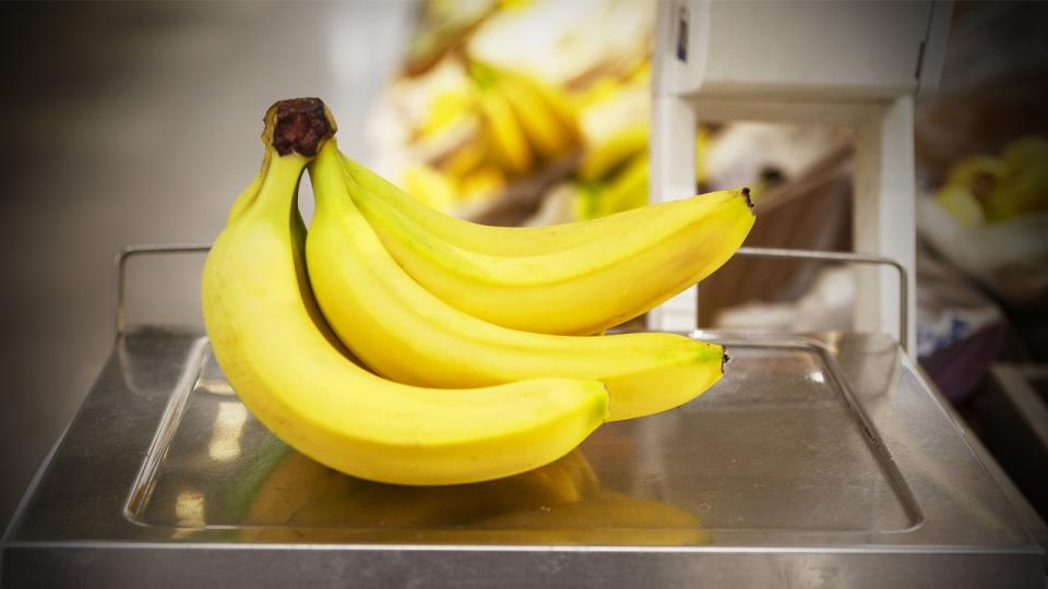 A bunch of bananas sitting on a cashier checkout scale.