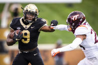 Wake Forest sophomore running back Kenneth Walker III (9) breaks a tackle by Virginia Tech cornerback Devin Taylor (24) during an NCAA college football game Saturday, Oct. 24, 2020, in Winston-Salem, N.C. (Andrew Dye/The Winston-Salem Journal via AP)