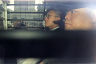 Hong Kong jailed activist Edward Leung, left, is escorted by Correctional Services officers in a prison van as he arrives high court for his sentence appeal in Hong Kong, Wednesday, Oct. 9, 2019. Last year, Leung was sentenced to six years in prison for his part in a violent nightlong clash with police over illegal street food hawkers two years ago. (AP Photo/Kin Cheung)