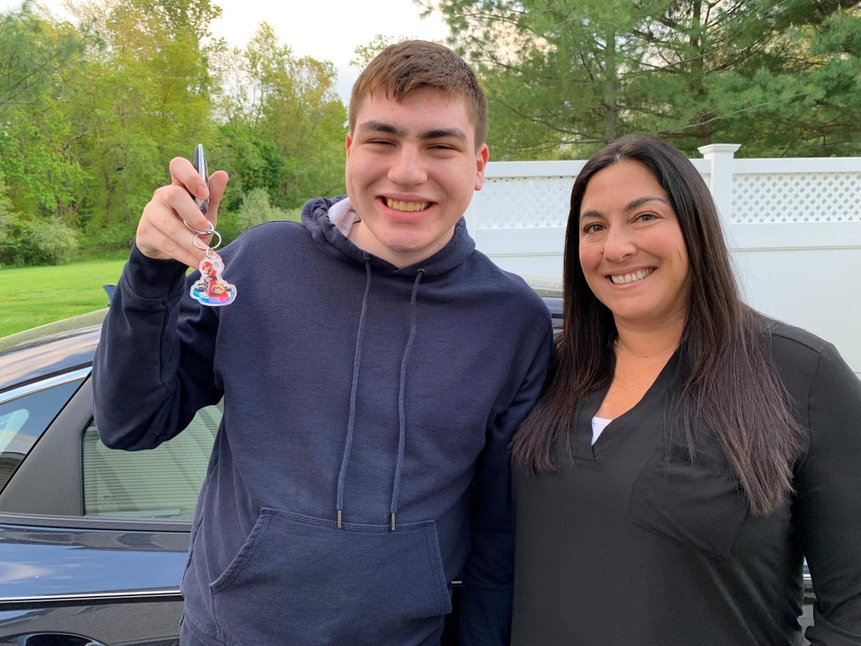 Jay Fisher holds up his car key next to mom Deb Fisher in Marlboro.