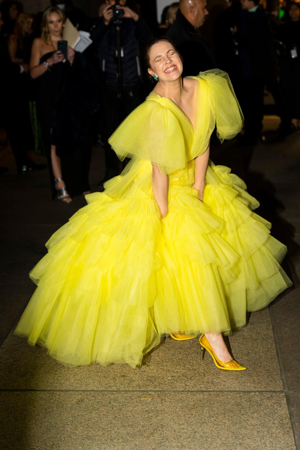 Barrymore wearing a lemon yellow tulle puff dress and yellow heels.