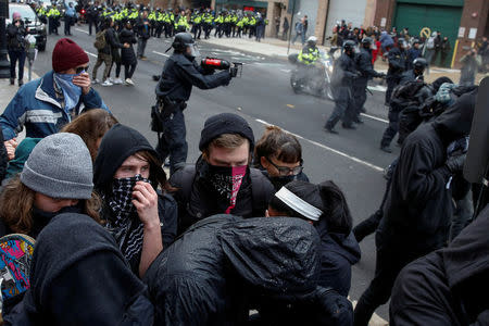 File Photo: Protesters demonstrating against U.S. President Donald Trump take cover as they are hit by pepper spray by police on the sidelines of the inauguration in Washington, DC, U.S., January 20, 2017. REUTERS/Adrees Latif/File Photo