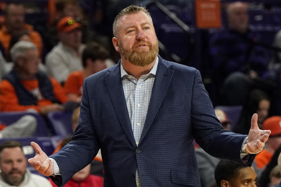 Queens University head coach Grant Leonard speaks during the first half of an NCAA basketball game against Clemson, Friday, Dec. 22, 2023, in Clemson, S.C. (AP Photo/Mike Stewart)