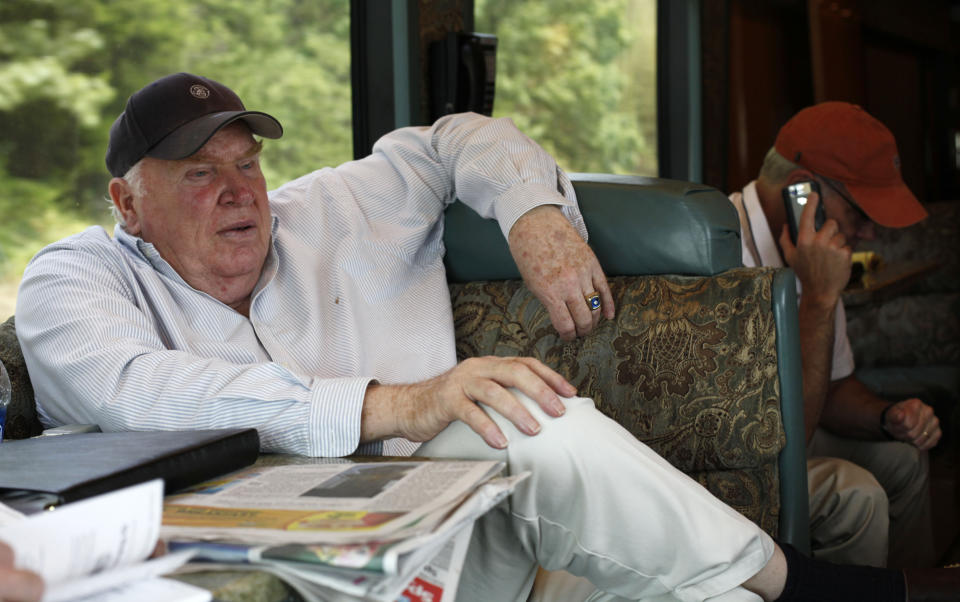 FILE - Former NFL coach and television analyst John Madden rides in his bus from the Baltimore Ravens' football camp to the Washington Redskins' camp Aug. 4, 2010, in Maryland. Hall of Fame football coach Madden is among the most famous for his trepidation with air travel. (AP Photo/Rob Carr, File)