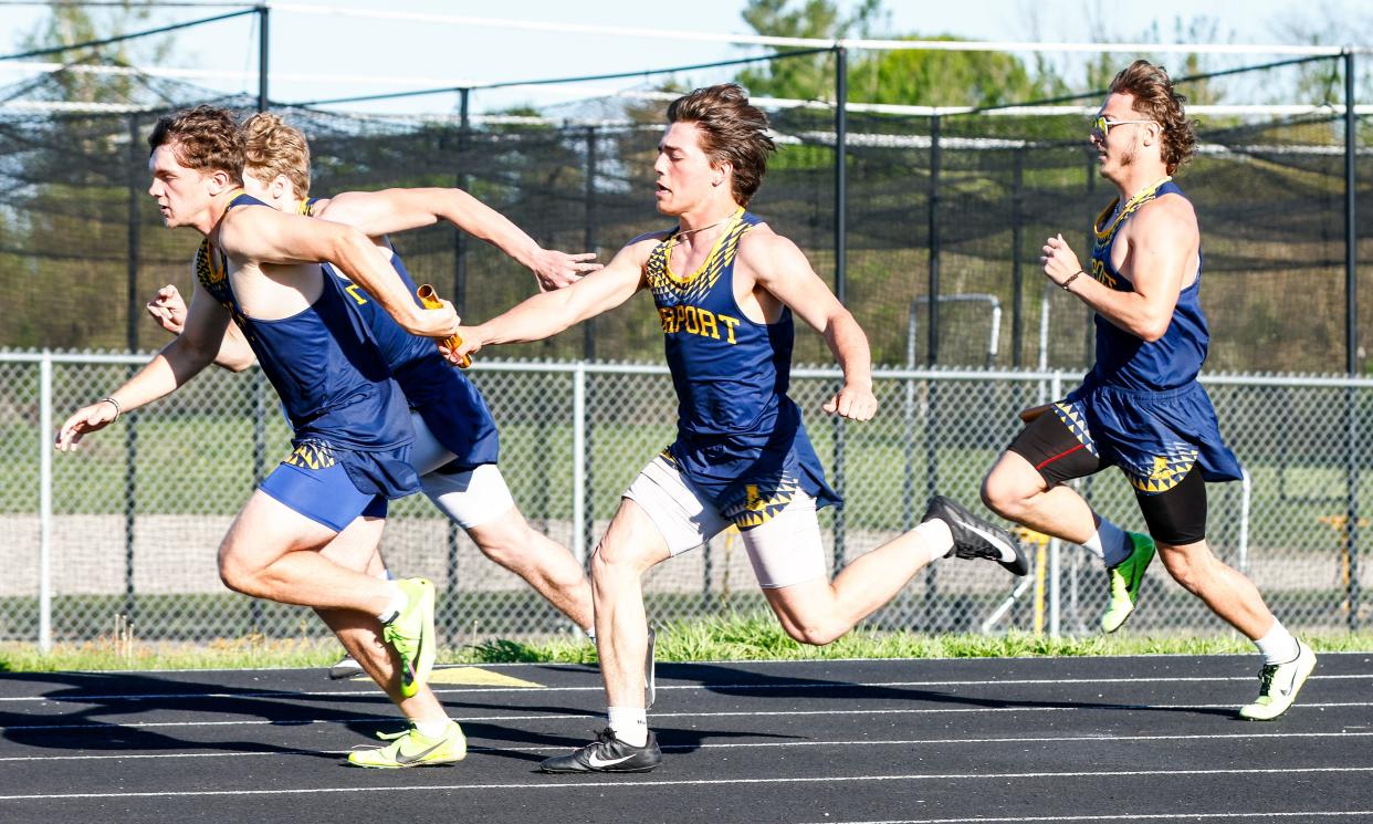 Caden Cooper and Tyler Carroll (inside) and Jordan Fields and Preston Falzon (outside) pass the baton for Airport during a meet against Grosse Ile on Tuesday, April 30, 2024.