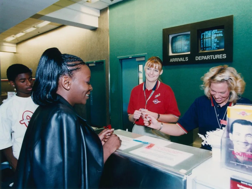 Southwest airlines customer service agents with customers at the ticket counter