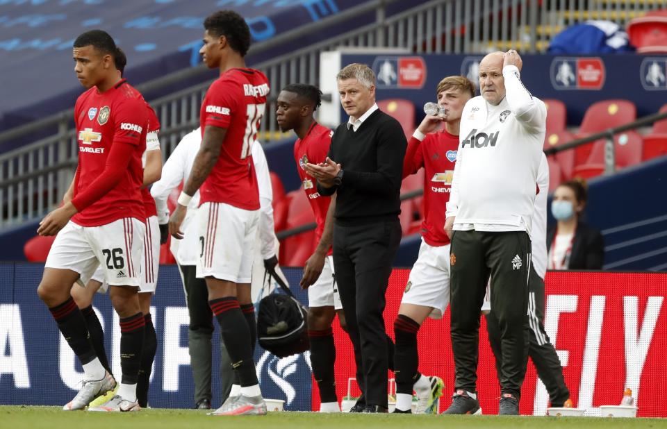 Manchester United's manager Ole Gunnar Solskjaer stands on the touchline during the English FA Cup semifinal soccer match between Chelsea and Manchester United at Wembley Stadium in London, England, Sunday, July 19, 2020. (Andy Rain, Pool via AP)