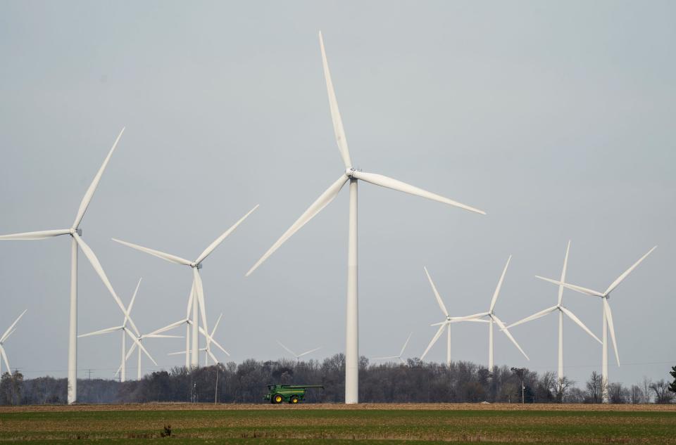 Wind turbines spin in the distance off of Van Geisen Road in Fairgrove on Thursday, Nov. 16, 2023.