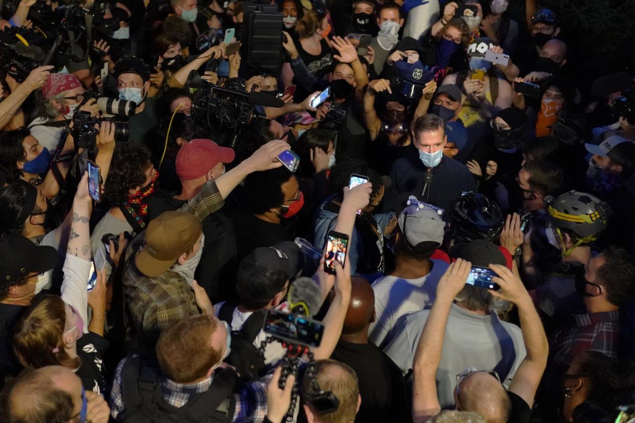 Portland Mayor Ted Wheeler speaks to the media while surrounded by press and protesters in front of the Multnomah County Justice Center on 22 July 2020 in Portland, Oregon: (2020 Getty Images)