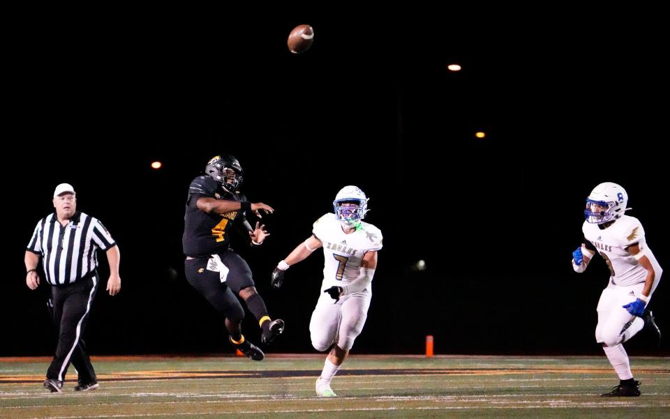 Sep 16, 2022; Scottsdale, Arizona, USA; Saguaro Sabercats quarterback Devon Dampier (4) throws to a touchdown pass to Joseph Clark (28) against Sandra Day O'Connor Eagles defensive end Jett Roufus (7) during a game played at Saguaro High. Mandatory Credit: Rob Schumacher-Arizona Republic