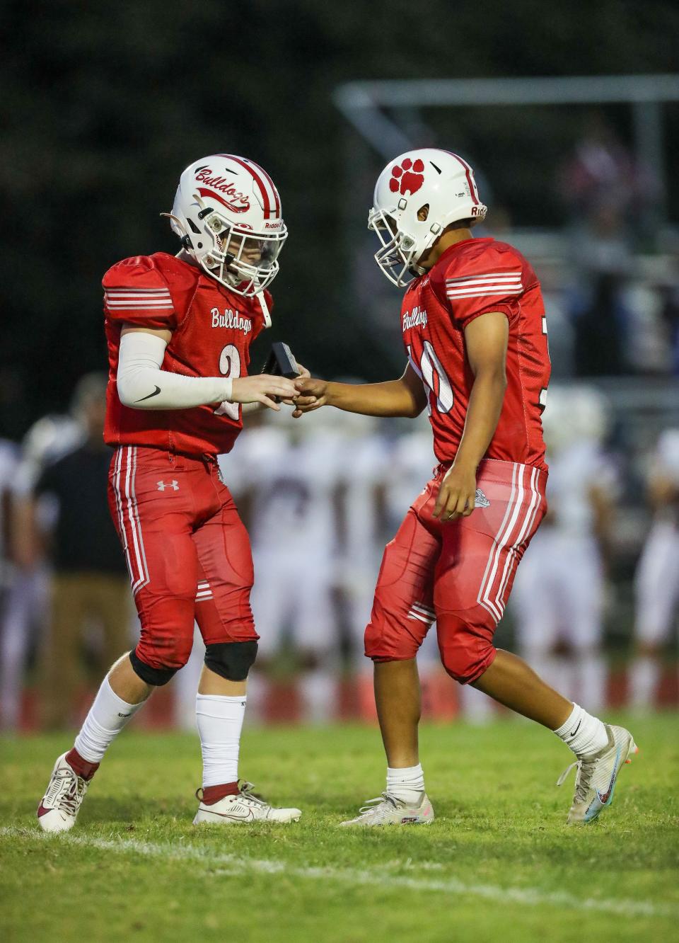 Bradley Lopez Vasquez (right) celebrates a successful kick with Elijah Niblett in Caravel’s 21-3 win over the Bulldogs, Friday, Sept. 22, 2023.