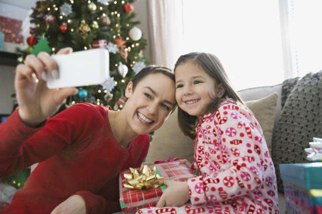 Mother and daughter taking self portrait during Christmas