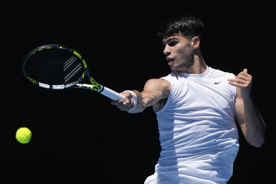 Spain's Carlos Alcaraz plays a forehand return during a practice session ahead of the Australian Open tennis championships at Melbourne Park, Melbourne, Australia, Thursday, Jan. 11, 2024. (AP Photo/Mark Baker)