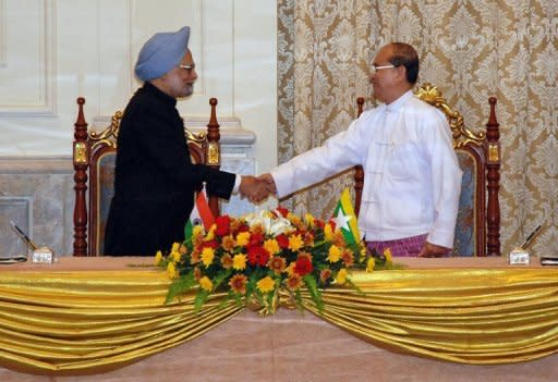 Visiting Indian Prime Minister Manmohan Singh (left) shakes hands with Myanmar President Thein Sein during their meeting at the president's house in Naypyidaw. India has agreed a raft of deals with Myanmar during a visit by Singh that is aimed at boosting trade and energy links and contesting the influence of regional rival China