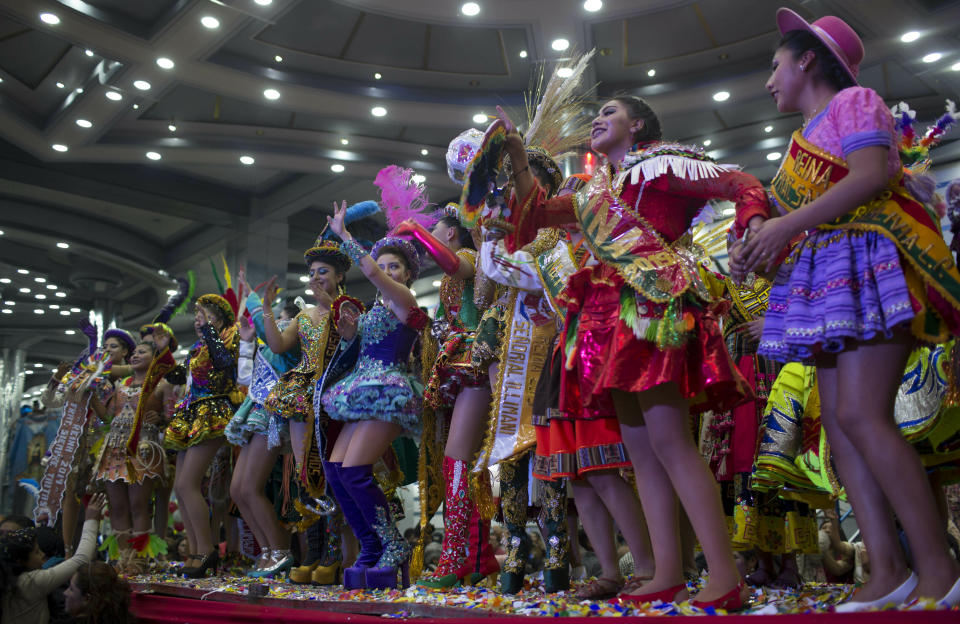 Contestants acknowledge the audience during the Queen of Great Power contest, in La Paz, Bolivia, Friday, May 24, 2019. The largest religious festival in the Andes choses its queen in a tight contest to head the Festival of the Lord Jesus of the Great Power, mobilizing thousands of dancers and more than 4,000 musicians into the streets of La Paz. (AP Photo/Juan Karita)