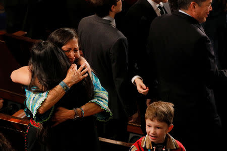 U.S. Representative Deb Haaland (D-NM) becomes emotional and hugs U.S. Representative Sharice Davids (D-KS) after they were sworn in as the first two first Native American women in the U.S. House of Representatives in Washington, U.S., January 3, 2019. REUTERS/Brian Snyder