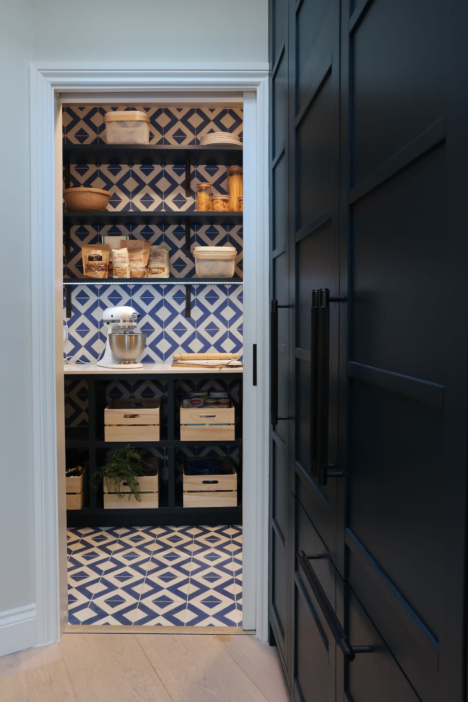 <p>Lucky enough to have your very own walk-in pantry? We love how this one feels like a natural extension of the kitchen with a mixture of shelves, drawers and work surface space. The vibrant blue and white tiles add a touch of something unique. </p><p>• See more from <a href="https://www.woodworksbrighton.co.uk/" rel="nofollow noopener" target="_blank" data-ylk="slk:Wood Works Brighton;elm:context_link;itc:0;sec:content-canvas" class="link ">Wood Works Brighton</a></p>