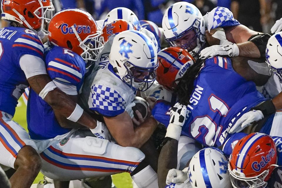 Kentucky quarterback Will Levis, center, scores a touchdown on a 1-yard run against Florida during the first half of an NCAA college football game, Saturday, Sept. 10, 2022, in Gainesville, Fla. (AP Photo/John Raoux)