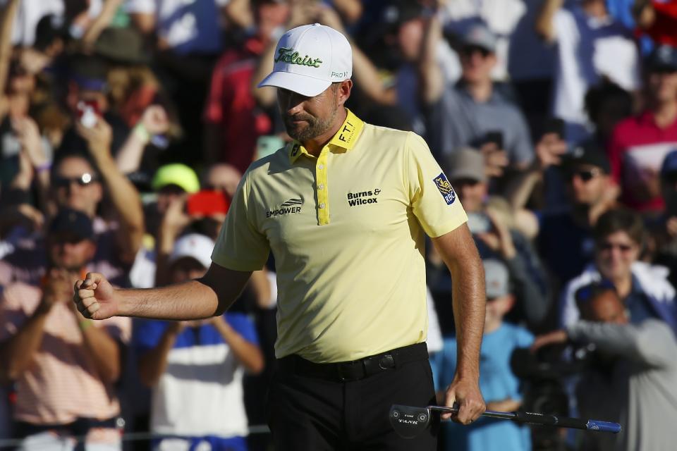 Webb Simpson pumps his fist after sinking the winning putt on the first playoff hole during the final round of the Waste Management Phoenix Open PGA Tour golf event Sunday, Feb. 2, 2020, in Scottsdale, Ariz. (AP Photo/Ross D. Franklin)