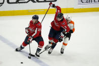 Washington Capitals defenseman Dmitry Orlov (9) gets tangled up between Washington Capitals left wing Daniel Carr (28) and Philadelphia Flyers right wing Nicolas Aube-Kubel (62) during the third period of an NHL hockey game, Friday, May 7, 2021, in Washington. The Flyers won 4-2. (AP Photo/Alex Brandon)