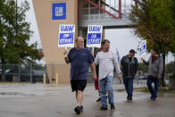 Ethan Pierce, left, a material handler of 23 years at General Motors, leads a line of picketers outside the company's assembly plant, Tuesday, Oct. 24, 2023, in Arlington, Texas. The United Auto Workers union is turning up the heat on General Motors as 5,000 workers walked off their jobs at the highly profitable SUV factory. (AP Photo/Julio Cortez)