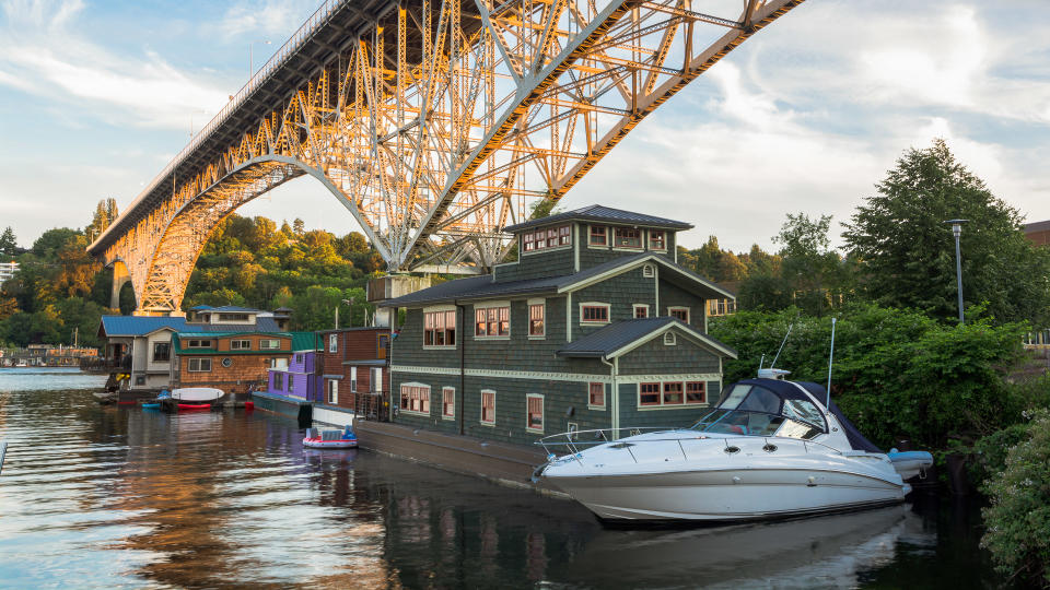 House boats on Lake Union in Seattle, WA with Aurora Bridge overhead.
