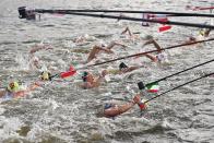 <p>TOPSHOT - Italy's Rachele Bruni (C) takes refreshment at a feed station along the course during the women's 10km marathon swimming event during the Tokyo 2020 Olympic Games at the Odaiba Marine Park in Tokyo on August 4, 2021. (Photo by Oli SCARFF / AFP) (Photo by OLI SCARFF/AFP via Getty Images)</p> 