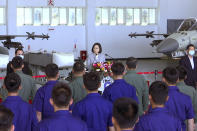 Taiwan President Tsai Ing-wen, center, speaks near Taiwan's Indigenous Defense Fighter (IDF) jets displayed during a visit to the Penghu Magong military air base in outlying Penghu Island, Taiwan Tuesday, Sept. 22, 2020. Tsai visited the military base on one of Taiwan’s outlying islands Tuesday in a display of resolve following a recent show of force by rival China. (AP Photo/Johnson Lai)