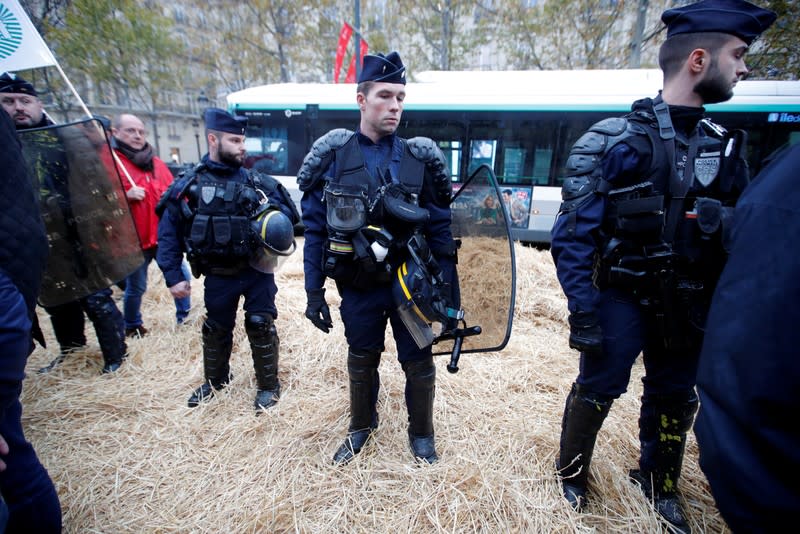 French farmers block the Champs Elysees avenue during a day of protest in Paris