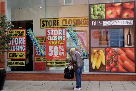 A pedestrian stands in front of a British Home Stores (BHS) branch in Chesterfield, Britain June 26, 2016. Photograph taken June 26, 2016. REUTERS/Andrew Yates