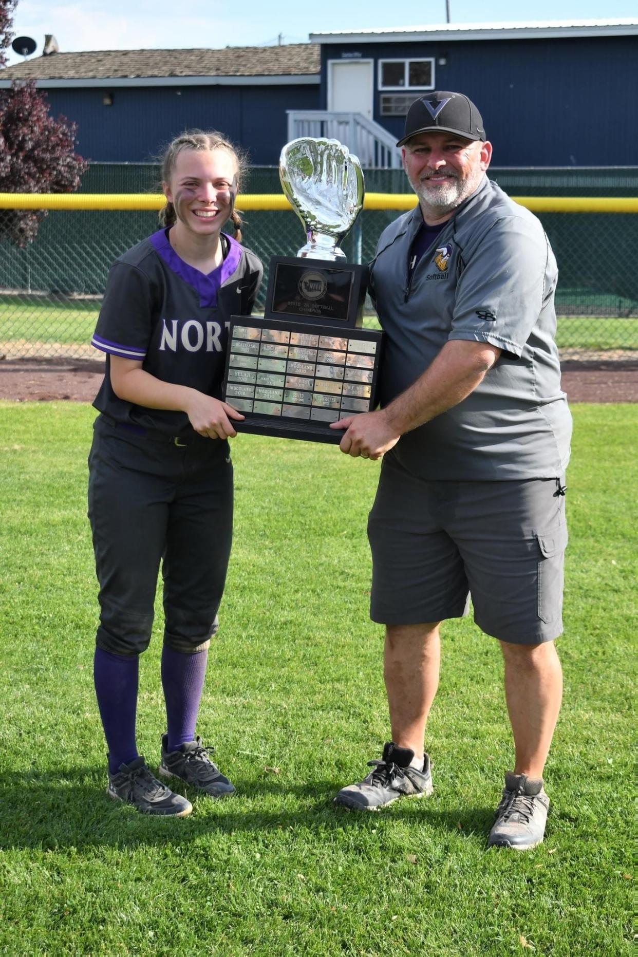 Reyna and Clay Blackwood hold the trophy after the North Kitsap softball team won the 2023 2A state championship.
