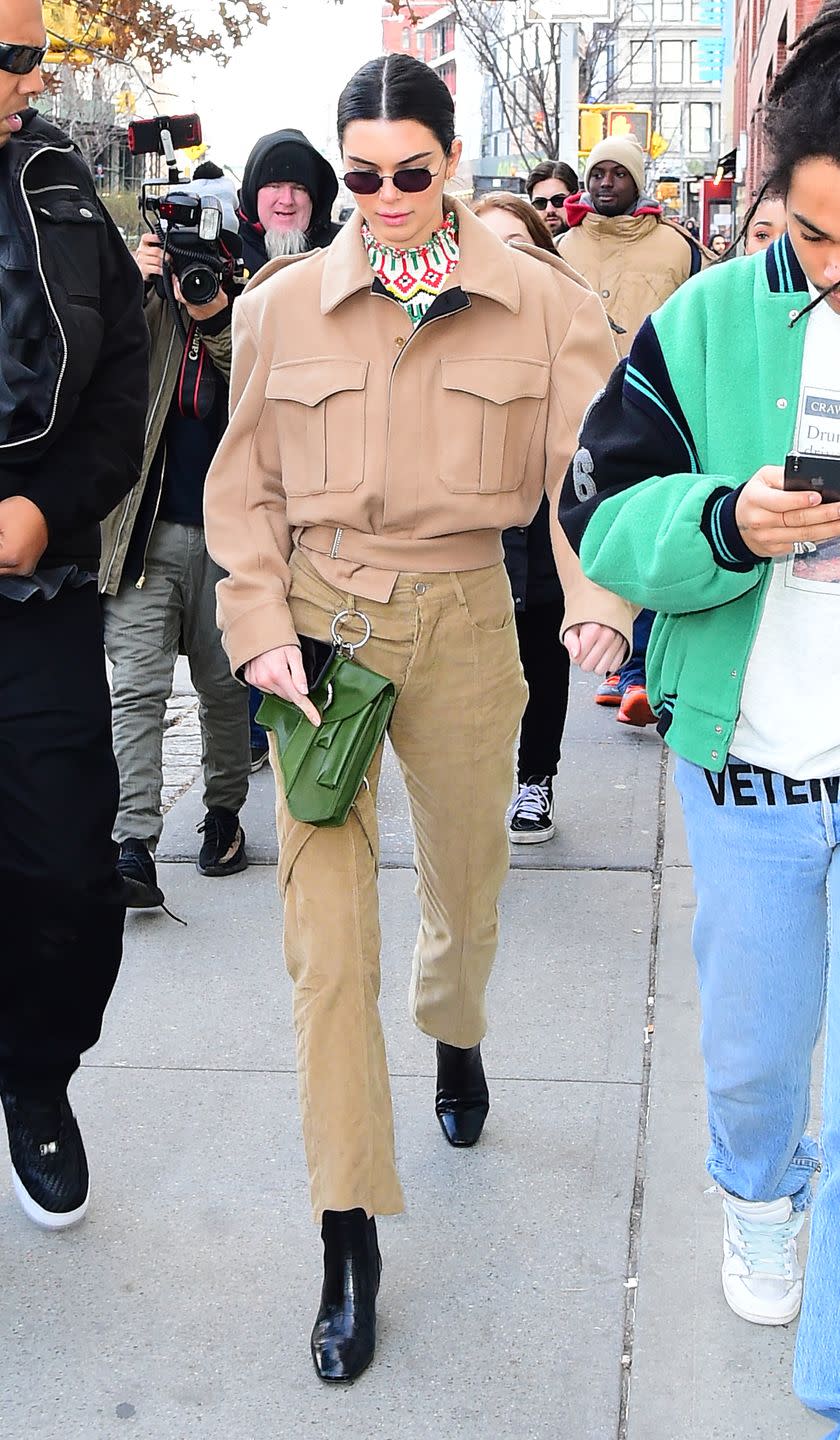 <p>The star wore a matching camel-coloured trouser and shirt combo for an afternoon out in New York City. She aded a pop of colour to her outfit with a green bag, February 2018</p>