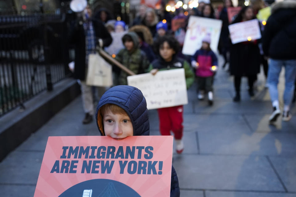 Charles Weaver, 8, marches at the front of a group of students, parents, and immigrant advocates near City Hall in New York, Tuesday, Dec. 19, 2023. The rally was held in response to an order New York Mayor Eric Adams issued in October limiting homeless migrants and their children to 60 days in city housing. (AP Photo/Seth Wenig)