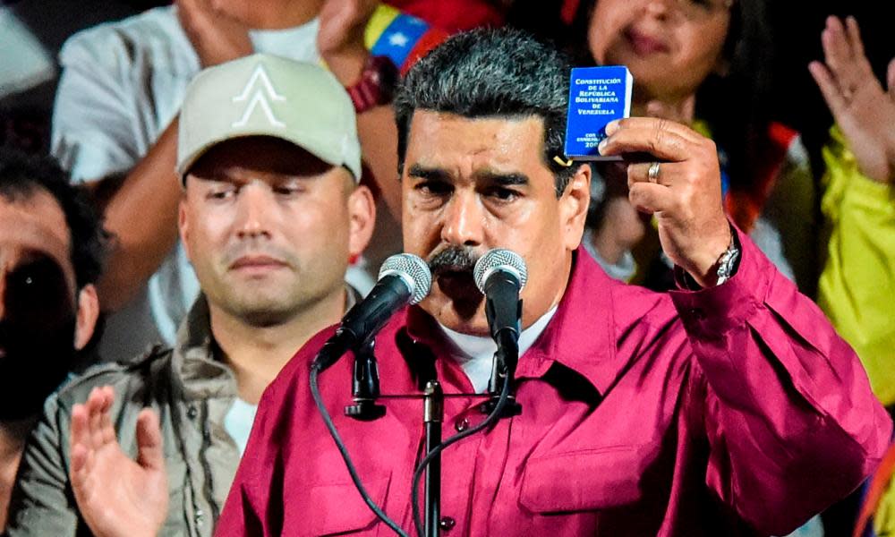 President Nicolás Maduro holds the political constitution of Venezuela