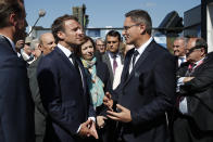 French President Emmanuel Macron talks with Eric Beranger, right, Chief Executive Officer of MBDA missile Systems, the 53rd International Paris Air Show at Le Bourget Airport near Paris, France, Monday June 17, 2019. The world's aviation elite are gathering at the Paris Air Show with safety concerns on many minds after two crashes of the popular Boeing 737 Max. (Benoit Tessier/Pool via AP)