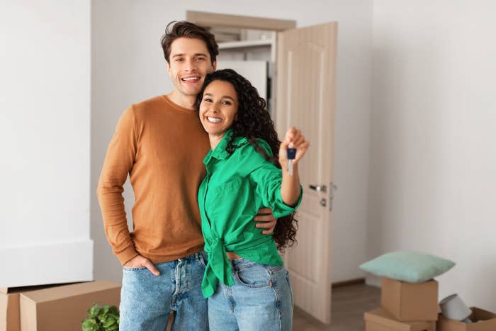 couple showing off the key to their new house