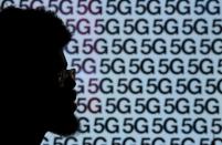 A man walks past an advertisement promoting the 5G data network at a mobile phone store in London